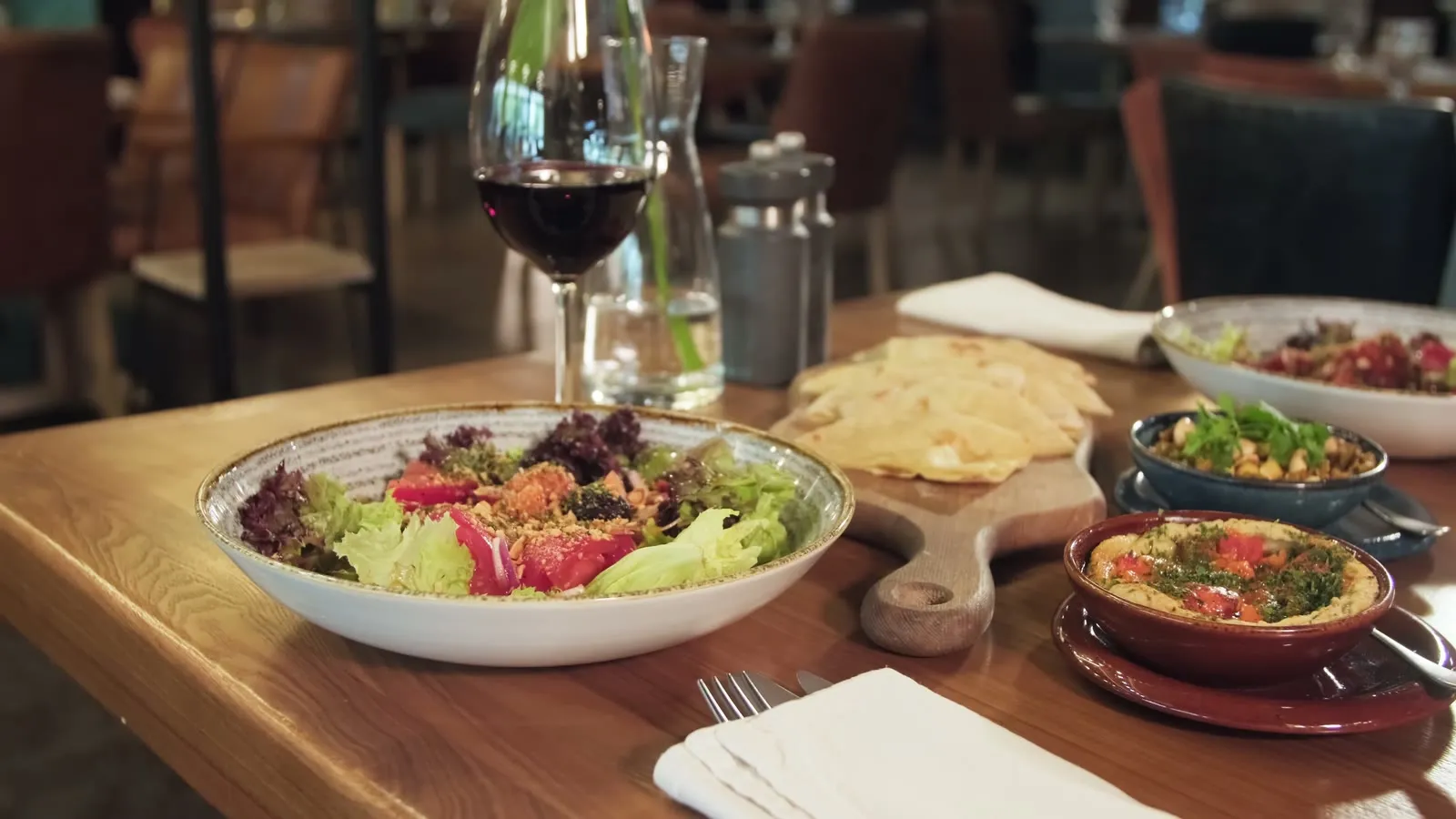 Dinner and wine set on a warmly lit restaurant table